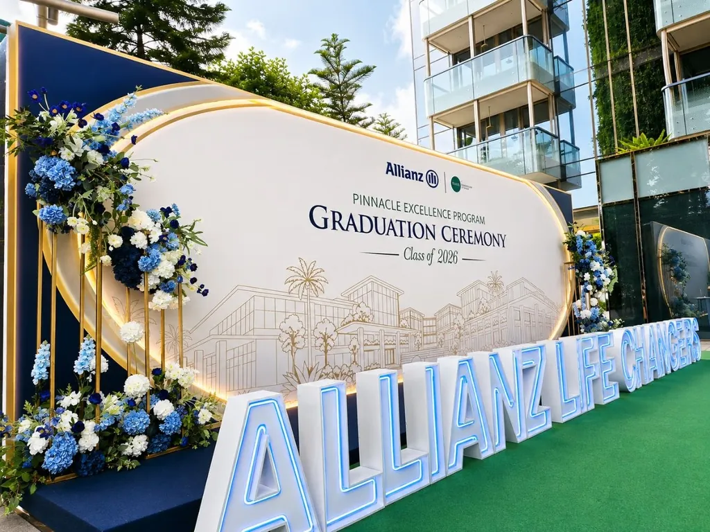 Graduation ceremony backdrop with blue and white floral arrangements and LED marquee letters in Singapore