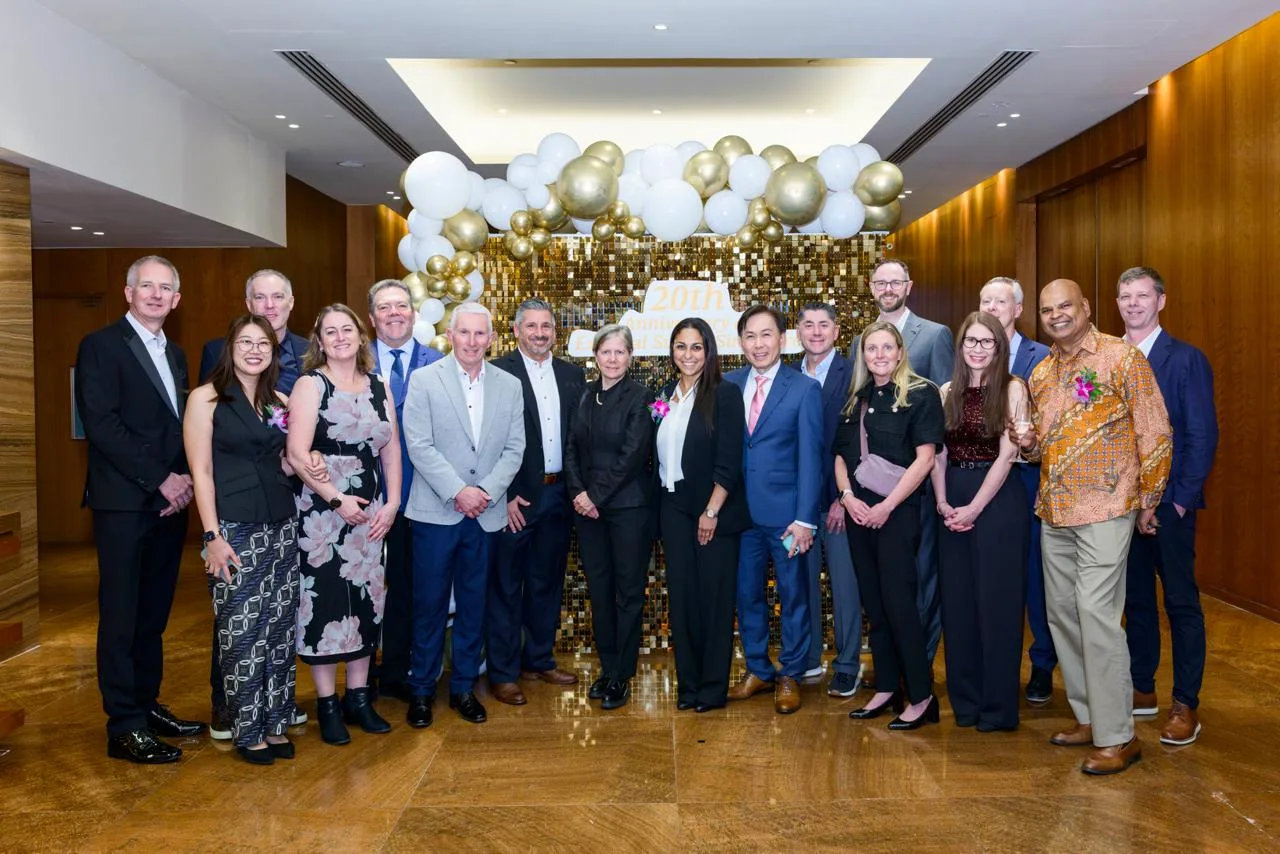 Corporate anniversary photo wall with gold balloons and sequins for Pfizer in Singapore